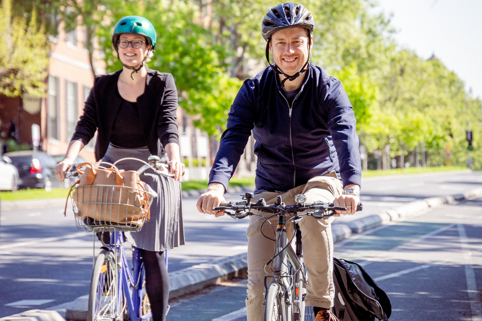 Sam and Kat Copsey riding their bikes on a safe bike lane